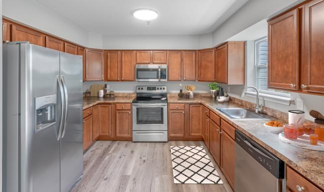 a kitchen with wooden cabinets