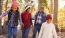 a group of people walking in the woods
