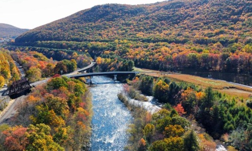 The essence of exceptional living a river with a bridge over it
